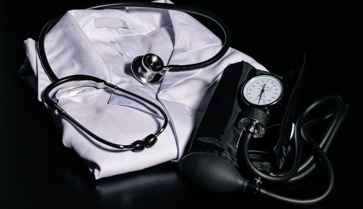 black and silver stethoscope on white textile